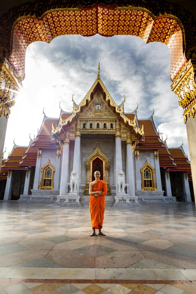 pexels-photo-3393546-3393546 A Buddhist monk standing in front of the iconic Wat Benchamabophit Temple, Bangkok, capturing spiritual tranquility.